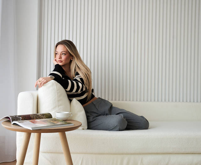 Ethereal White Resort Heraklion guest sitting at the couch admiring the view