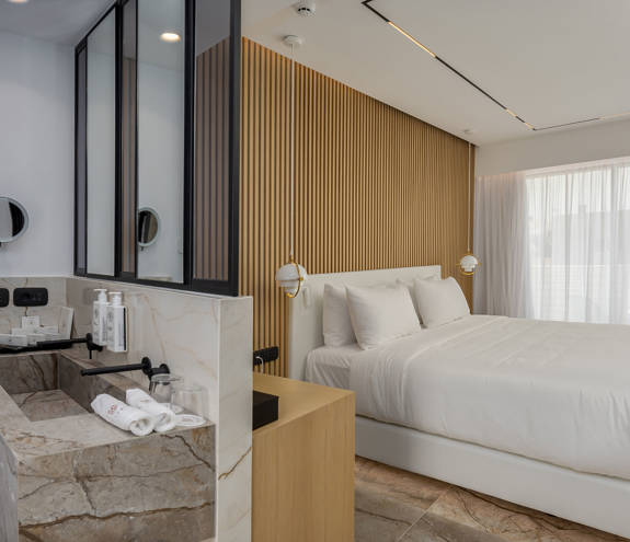 Ethereal White Resort Heraklion Deluxe Suite Swim Up double bed and washbasin