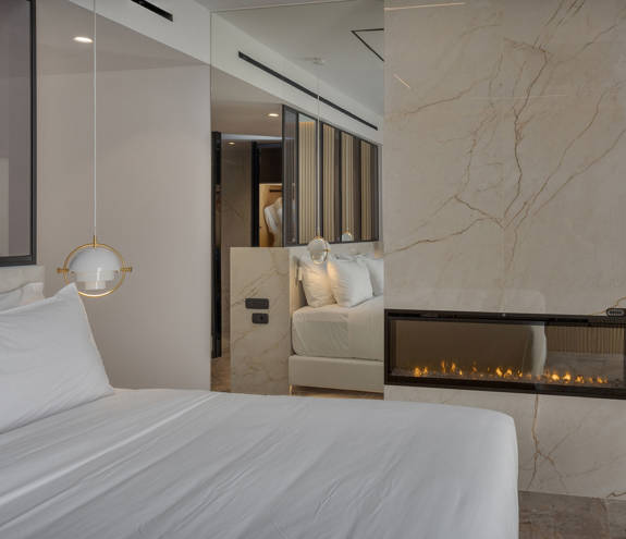 Ethereal White Resort Heraklion Luxury Suite bed and fireplace