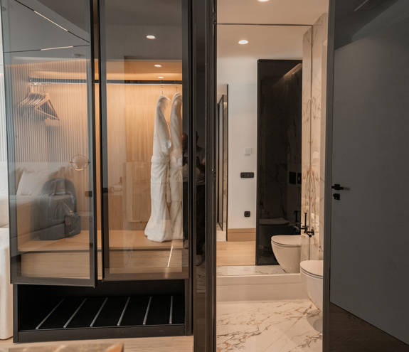 Ethereal White Resort Heraklion Deluxe Suite wardrobe and bathroom entrance