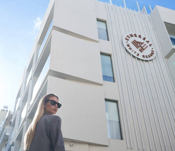 Person with the Ethereal White Resort Heraklion in the background