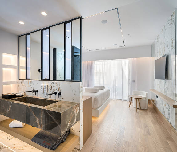 Ethereal White Resort Heraklion Junior Suite washbasins and the double bed in the background