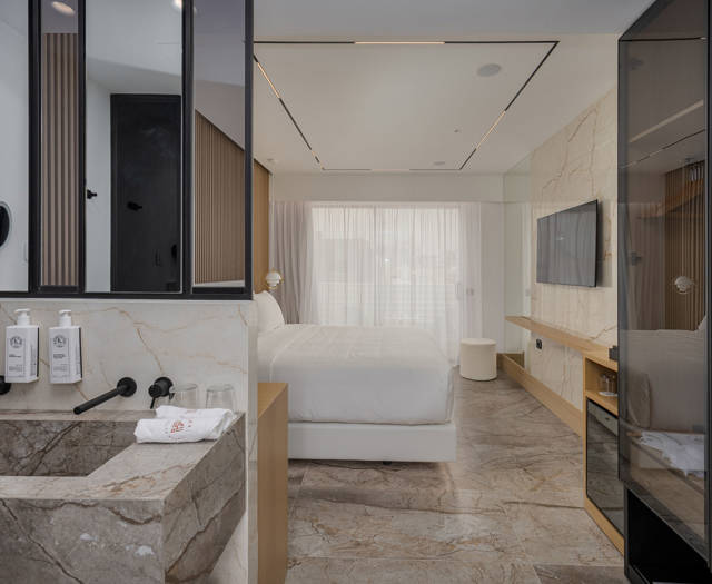 Ethereal White Resort Heraklion Deluxe Suite Swim Up washbasin and the double bed in the background
