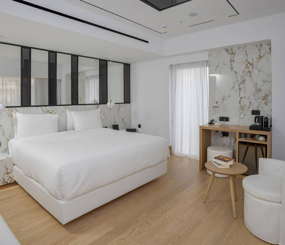 Ethereal White Resort Heraklion Luxury Suite double bed, desk, table and chair