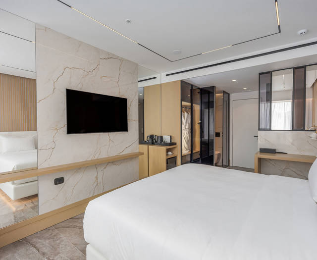 Ethereal White Resort Heraklion Deluxe Suite Swim Up double bed and room amenities