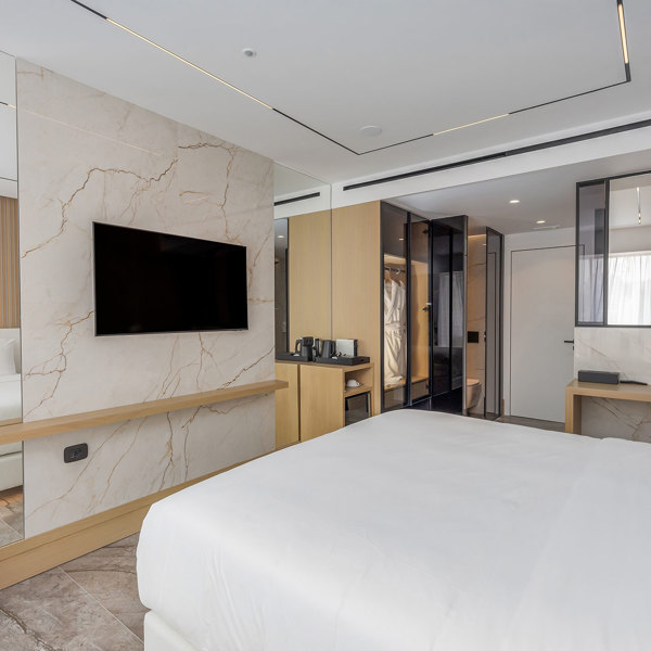 Ethereal White Resort Heraklion Deluxe Suite Swim Up double bed and room amenities