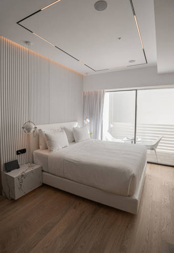 Ethereal White Resort Heraklion Deluxe Suite double bed and balcony view