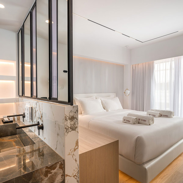 Ethereal White Resort Heraklion Junior Suite washbasins and the double bed in the background